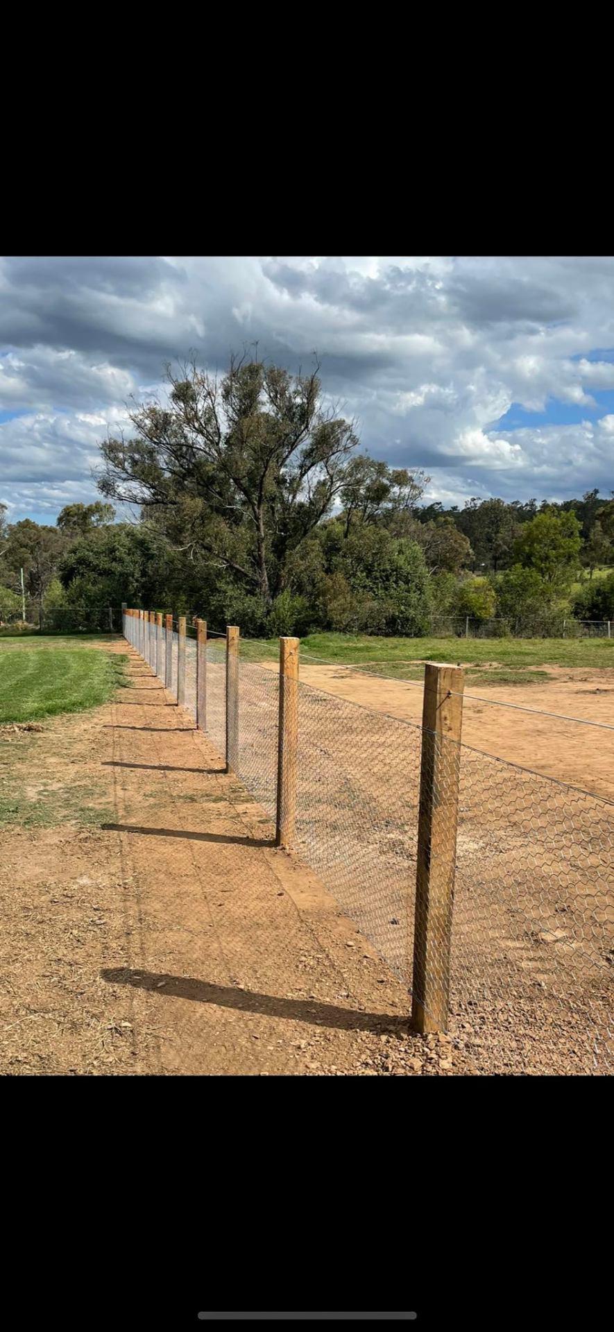Timber post chainmesh fence line