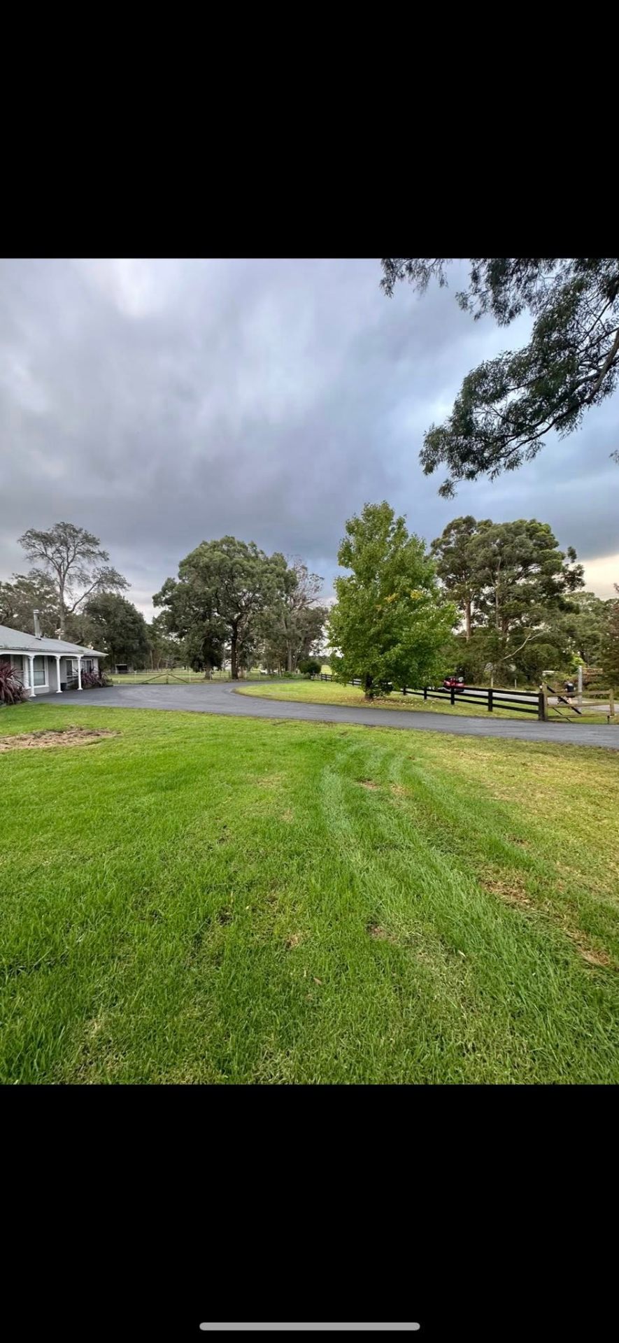 Sealed driveway with manicured lawn surrounds