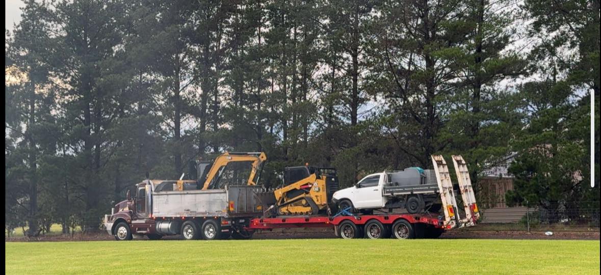 Excavator, skid steer & ute loaded for transport