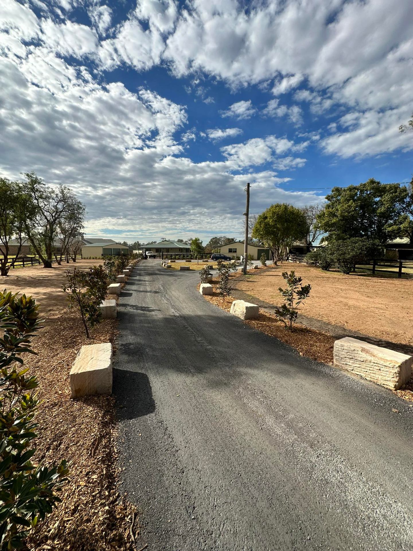 Landscaped driveway with sandstone blocks & magnolias