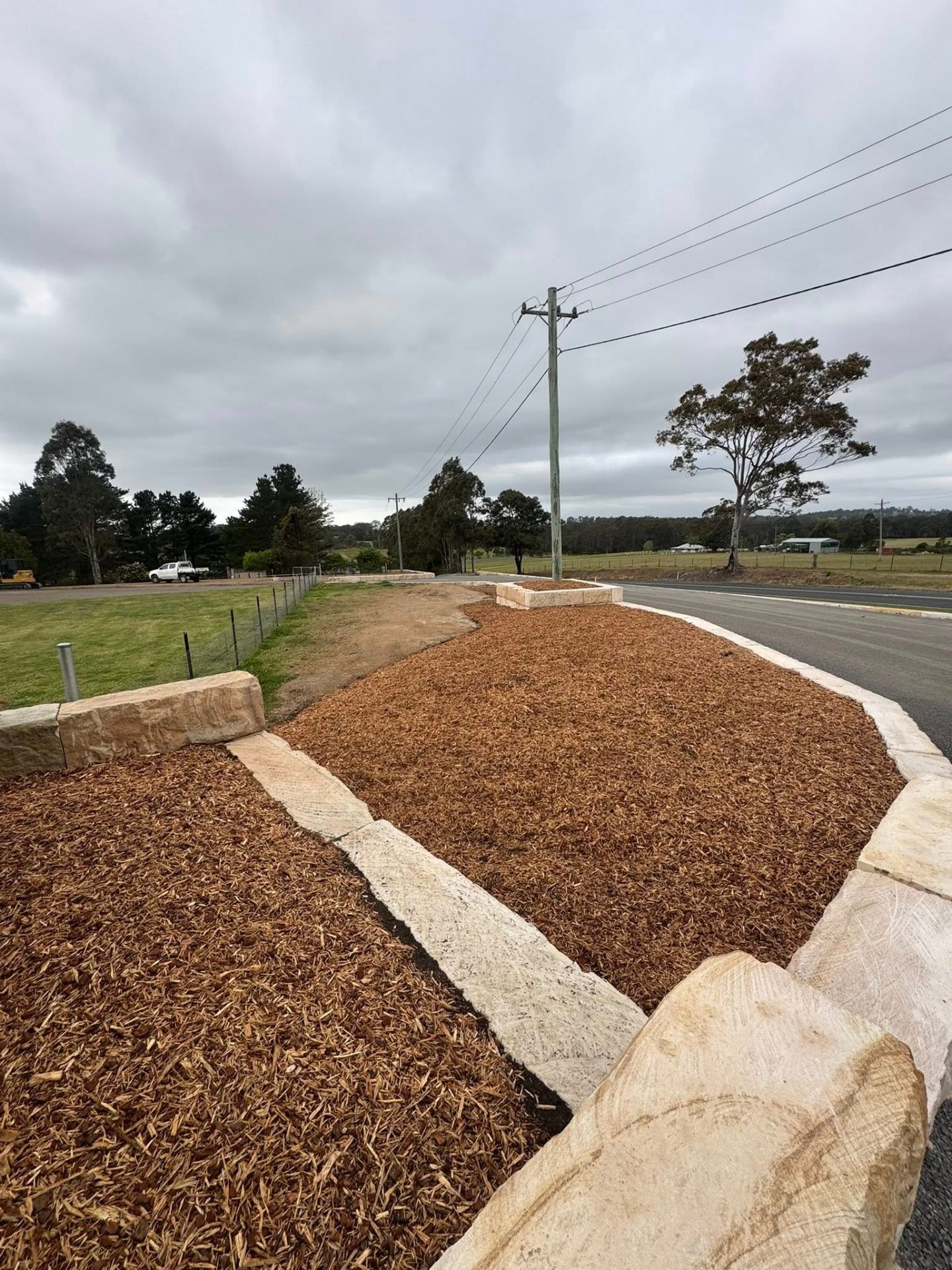 Sandstone-edged garden bed with mulch finish