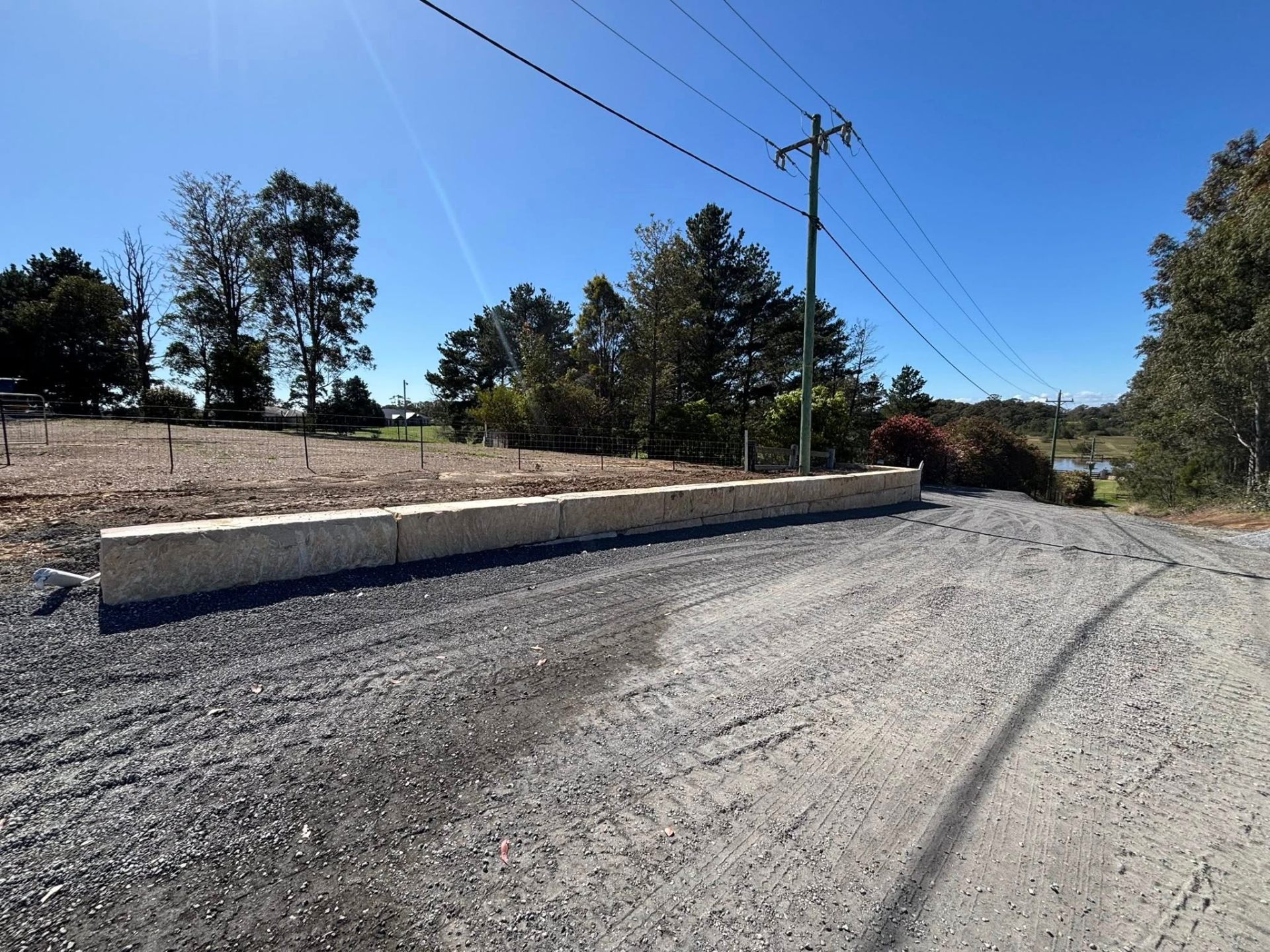 Sandstone retaining wall along paddock edge