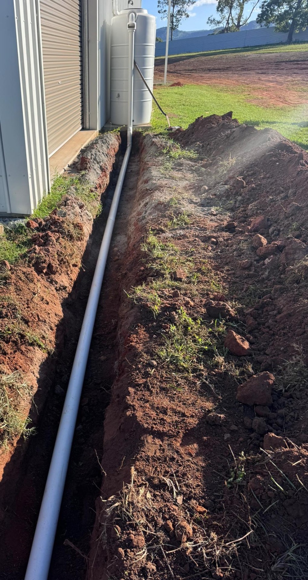 Service trench & stormwater pipe along shed