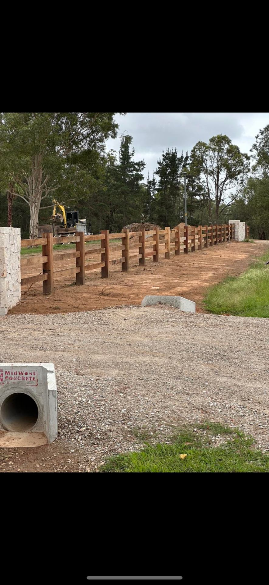Timber post & rail fence with culvert pipe
