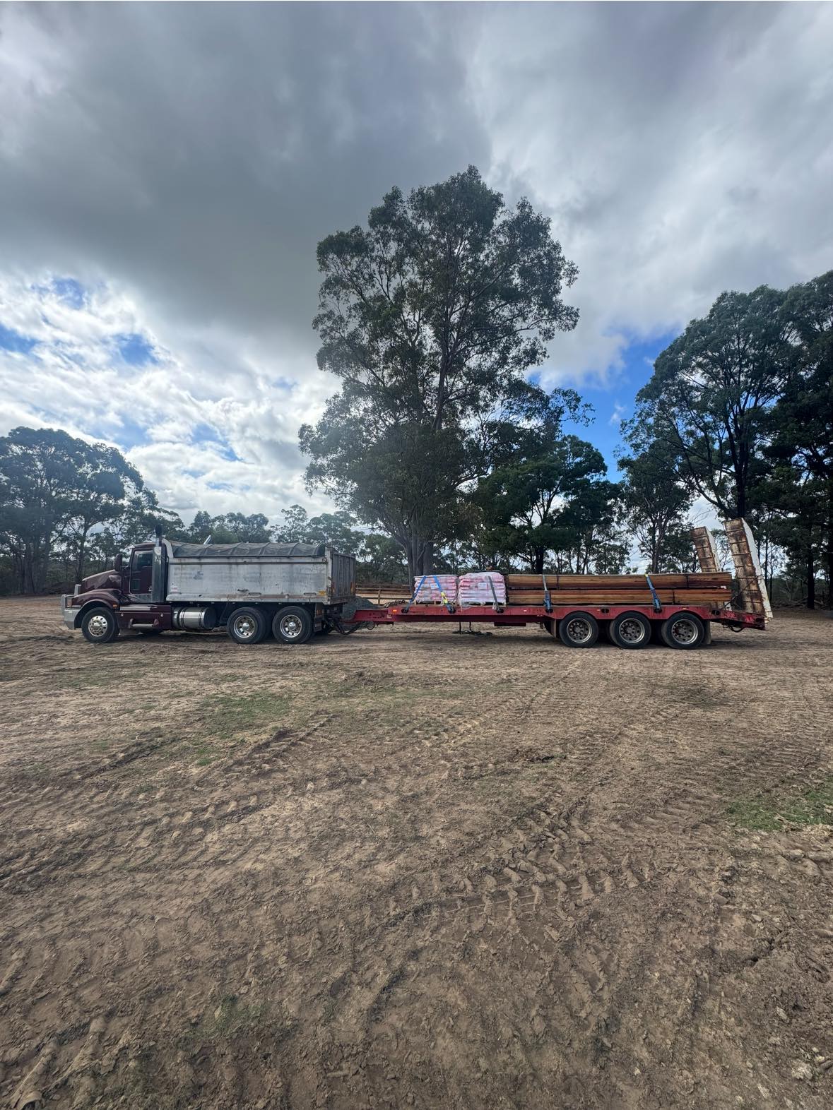 Tipper & float delivering materials on site